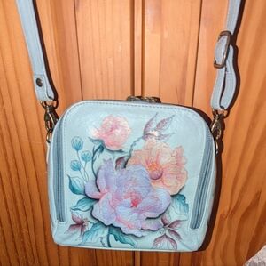 Anuschka zip around travel organizer crossbody bag.